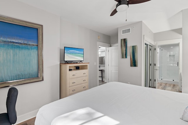 bedroom featuring ceiling fan, dark hardwood / wood-style floors, ensuite bathroom, and a closet