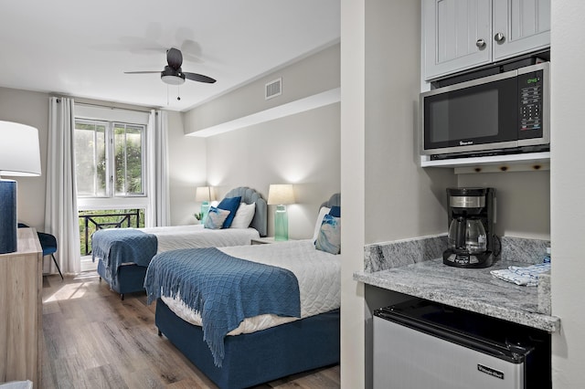 bedroom with ceiling fan and hardwood / wood-style floors