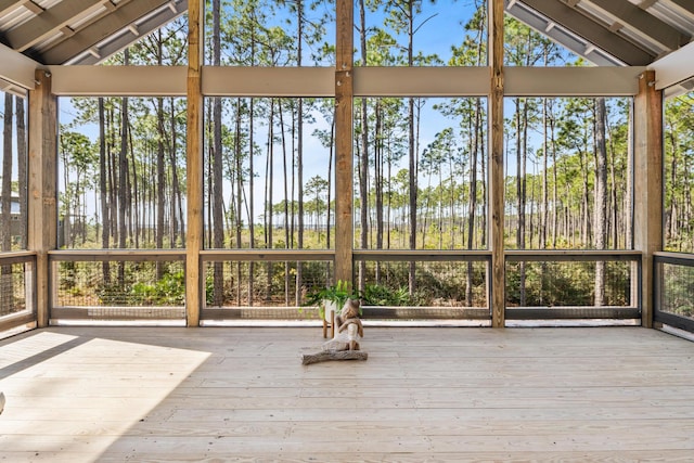 unfurnished sunroom featuring plenty of natural light and lofted ceiling