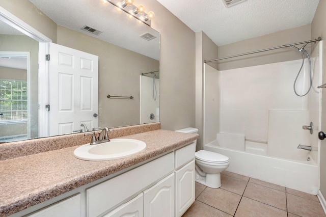 full bathroom with tile patterned floors, shower / bathtub combination, vanity, a textured ceiling, and toilet