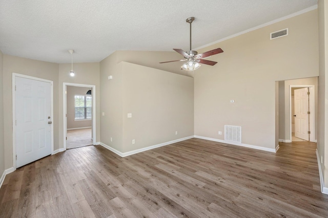 unfurnished living room featuring ceiling fan, hardwood / wood-style floors, high vaulted ceiling, and a textured ceiling