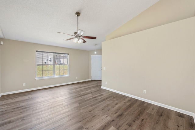 spare room with ceiling fan, dark wood-type flooring, and a textured ceiling