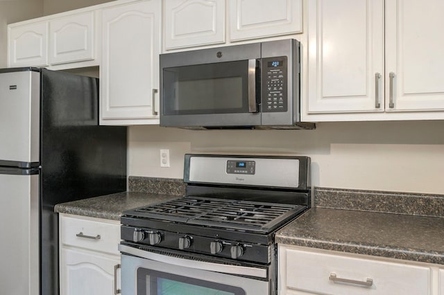 kitchen featuring white cabinets and appliances with stainless steel finishes