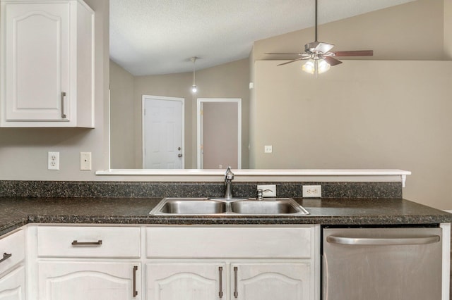 kitchen with dishwasher, lofted ceiling, white cabinets, sink, and a textured ceiling