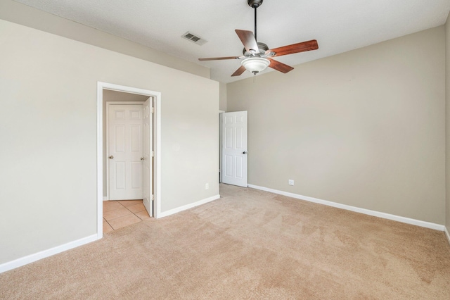 unfurnished bedroom with ceiling fan and light colored carpet