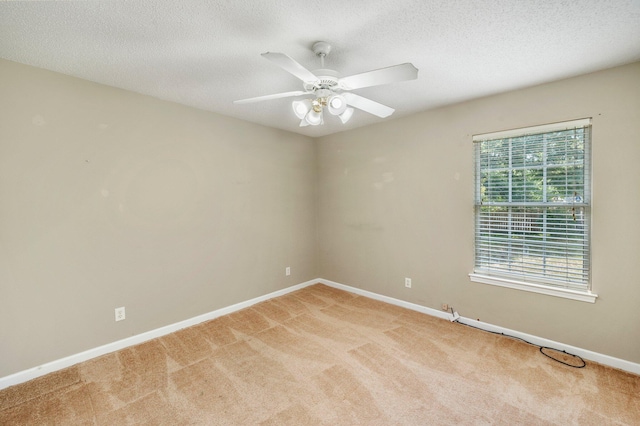 unfurnished room featuring light carpet, ceiling fan, and a textured ceiling