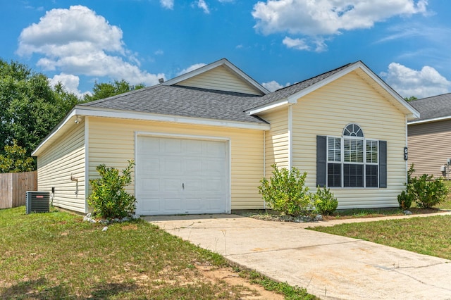 view of front facade featuring a front yard, a garage, and central AC unit