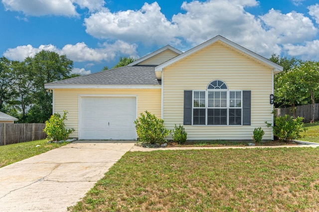 ranch-style home featuring a garage and a front yard