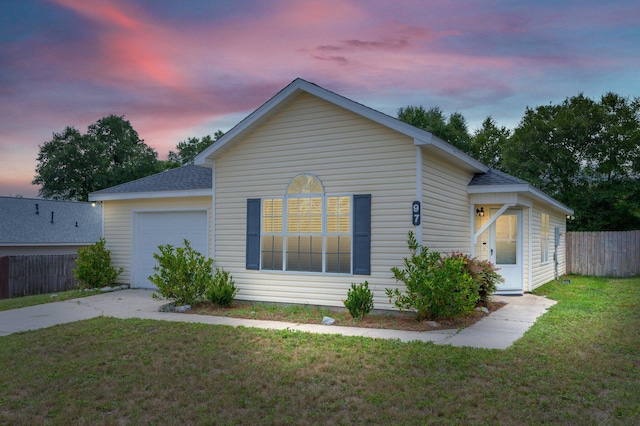 view of front of home featuring a yard and a garage