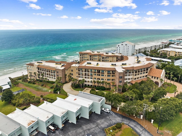 drone / aerial view featuring a beach view and a water view