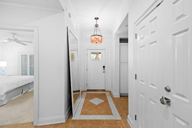 entrance foyer with crown molding, light tile patterned floors, and ceiling fan with notable chandelier