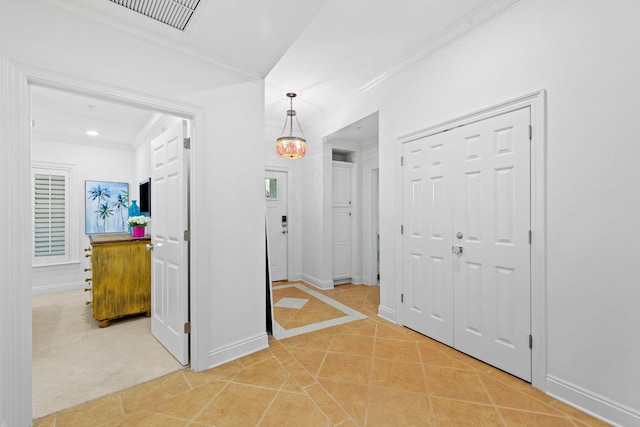 hallway featuring carpet and crown molding