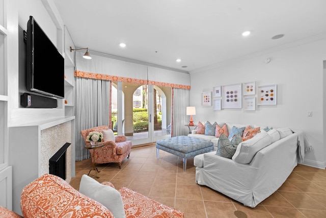 tiled living room with ornamental molding and a tile fireplace