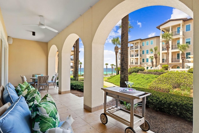 view of patio / terrace featuring ceiling fan, a water view, and an outdoor hangout area