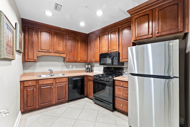 kitchen featuring black appliances, light tile patterned flooring, and sink