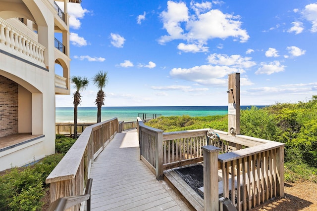 view of home's community with a water view and a view of the beach