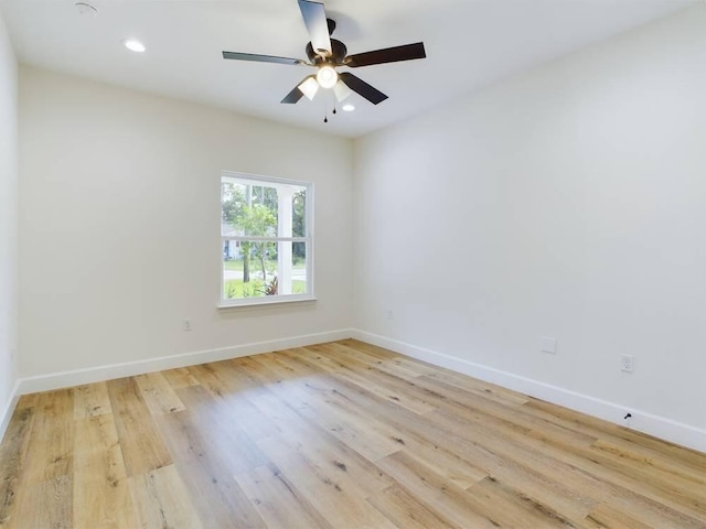 empty room with ceiling fan and light wood-type flooring