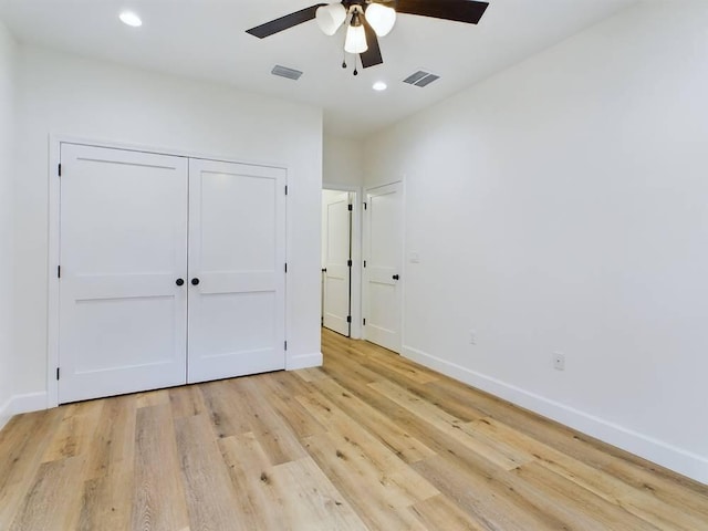 unfurnished bedroom with ceiling fan, a closet, and light hardwood / wood-style floors