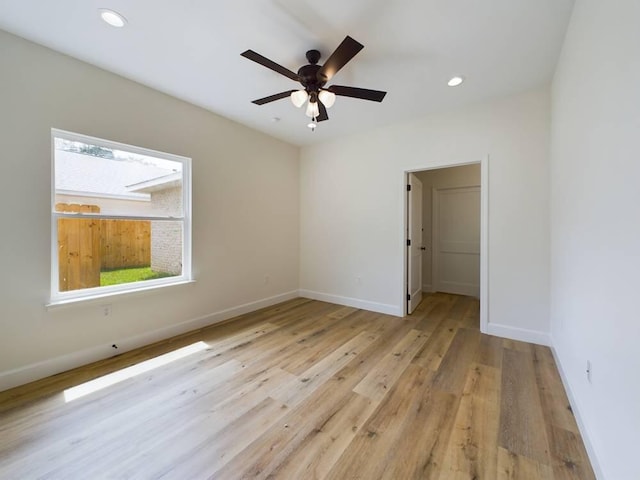 unfurnished room with ceiling fan and light hardwood / wood-style flooring