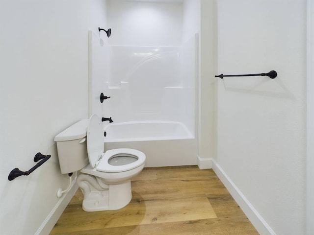 bathroom featuring shower / tub combination, toilet, and hardwood / wood-style flooring