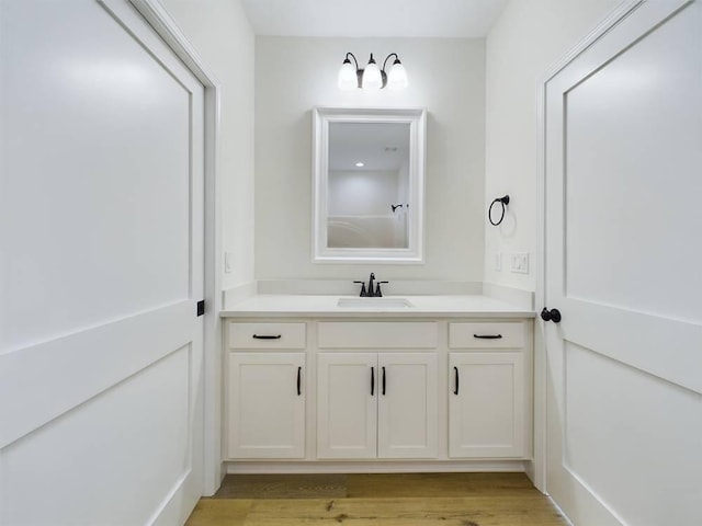 bathroom with vanity and hardwood / wood-style flooring