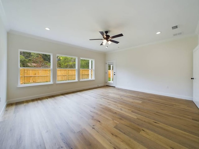 spare room featuring light hardwood / wood-style flooring, ceiling fan, and crown molding