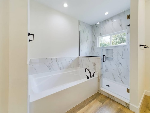 bathroom with hardwood / wood-style floors and plus walk in shower