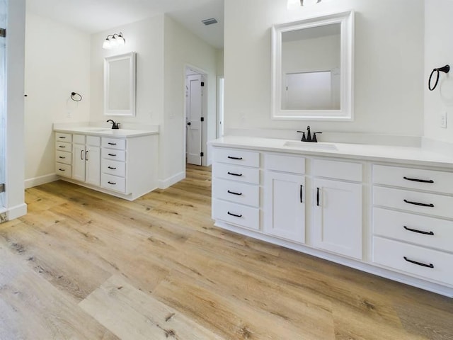 bathroom with hardwood / wood-style floors and vanity