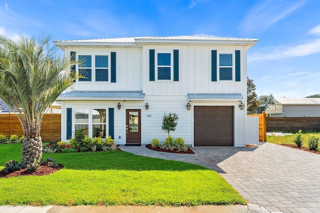 view of front of home featuring a garage and a front lawn