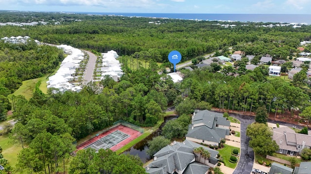 birds eye view of property with a residential view, a water view, and a wooded view