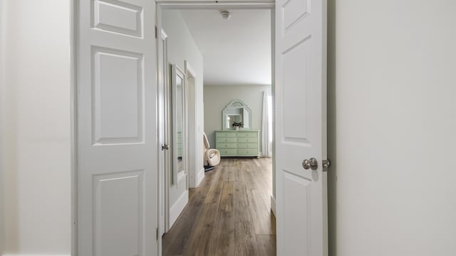 hallway with dark hardwood / wood-style flooring