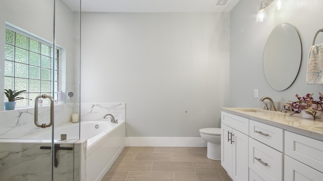 bathroom with a garden tub, a shower with door, toilet, vanity, and baseboards