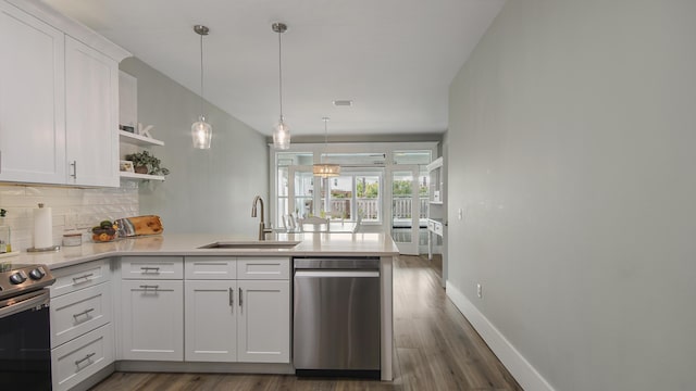 kitchen with stainless steel appliances, a peninsula, open shelves, and white cabinetry