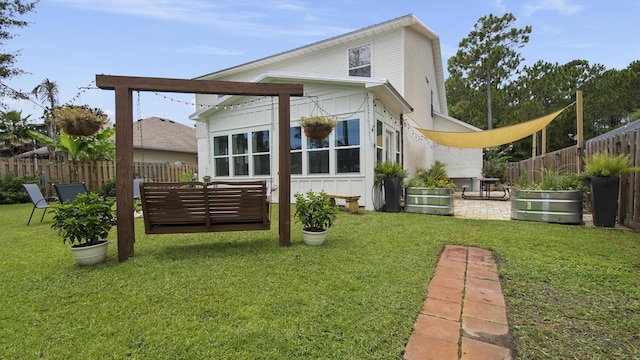 back of property featuring an outdoor living space, a patio area, and a yard