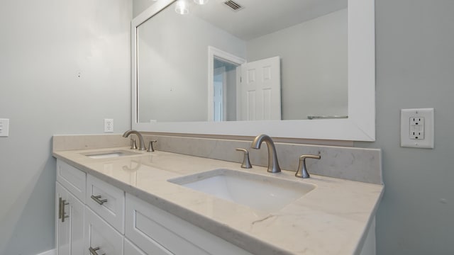 bathroom featuring double vanity, visible vents, and a sink