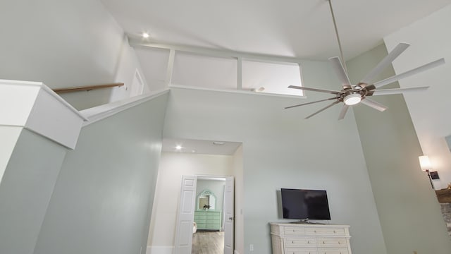 interior space featuring ceiling fan and high vaulted ceiling