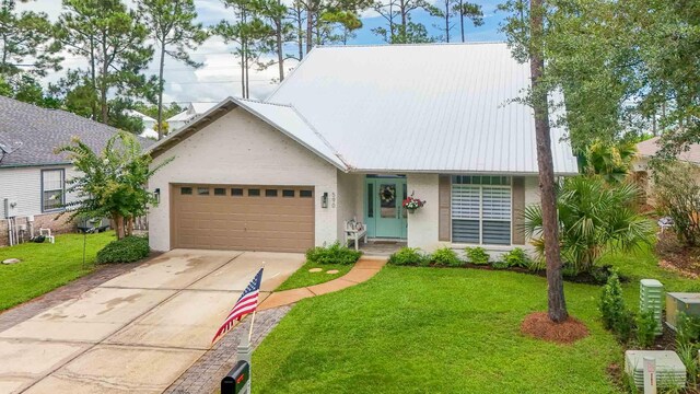 view of front of home featuring a front lawn and a garage