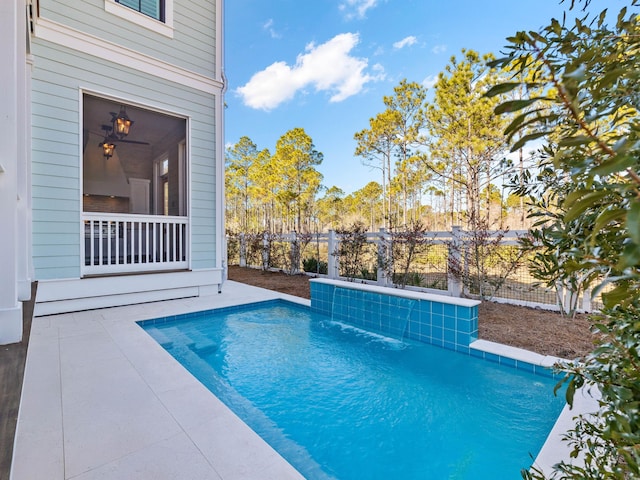 view of swimming pool with pool water feature and a patio