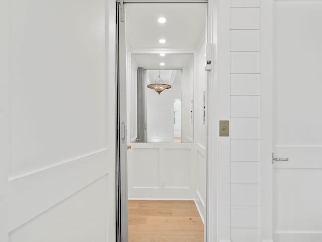 interior space with light wood-type flooring and elevator