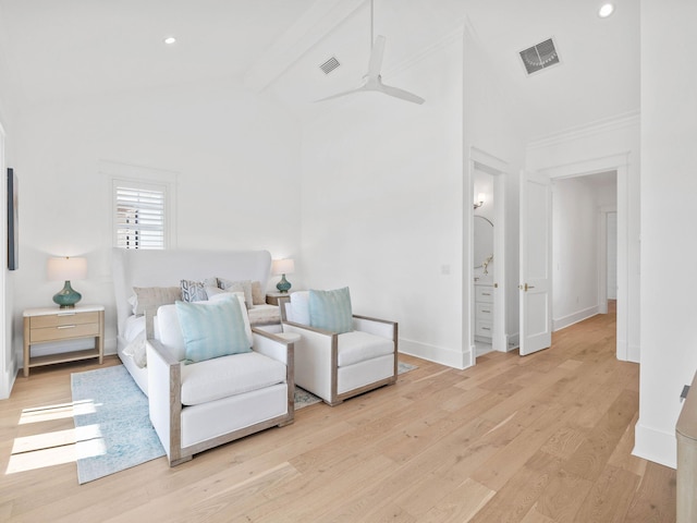 bedroom with ceiling fan, light hardwood / wood-style floors, and beam ceiling