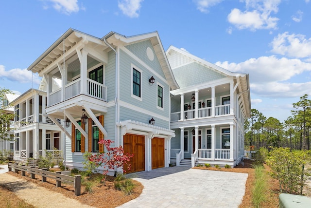 220 Climbing Rose Way, Santa Rosa Beach, FL 32459 - view of front facade featuring a balcony, a porch, an attached garage, and decorative driveway