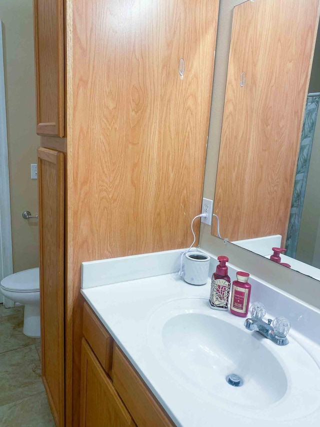 bathroom featuring vanity and toilet