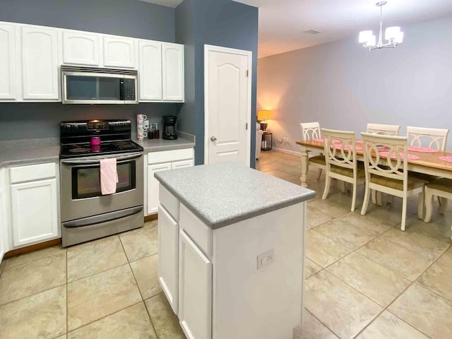 kitchen featuring a center island, hanging light fixtures, stainless steel appliances, light tile patterned floors, and white cabinets