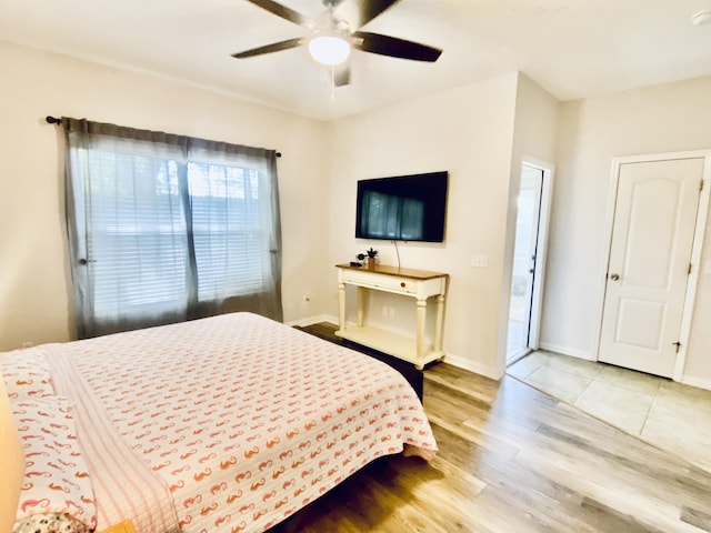 bedroom with access to exterior, ceiling fan, and light hardwood / wood-style flooring