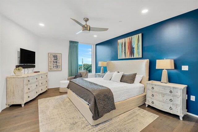 bedroom with hardwood / wood-style floors and ceiling fan