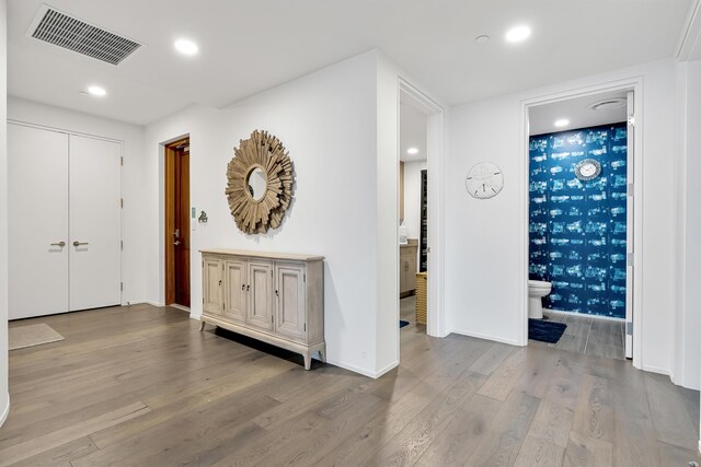 hall with hardwood / wood-style floors