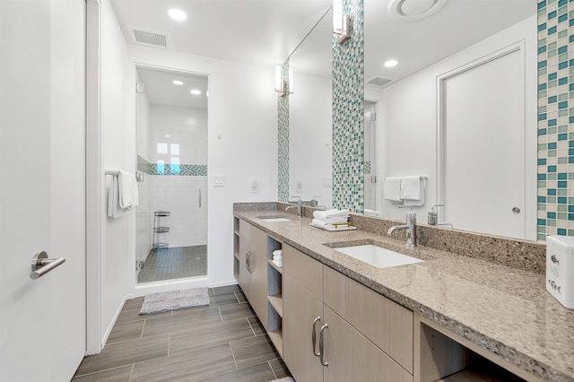 bathroom with an enclosed shower, tile patterned flooring, and dual bowl vanity