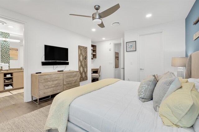 bedroom with wood-type flooring, ensuite bathroom, and ceiling fan