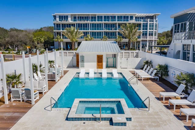 view of pool featuring a wooden deck and a community hot tub