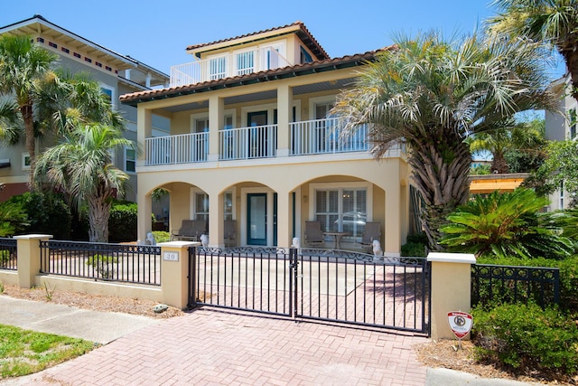 mediterranean / spanish home with covered porch and a balcony